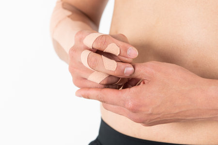 Close-up of a man with adhesive bandage on his arm