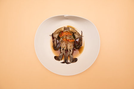Steamed blue crab in white plate on orange background, top viewの写真素材