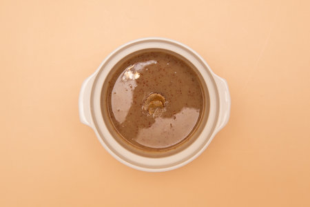 Coffee in a white cup on a brown background, top viewの写真素材