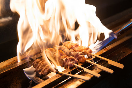 Grilled chicken on skewers on barbecue grill in the restaurant.の写真素材