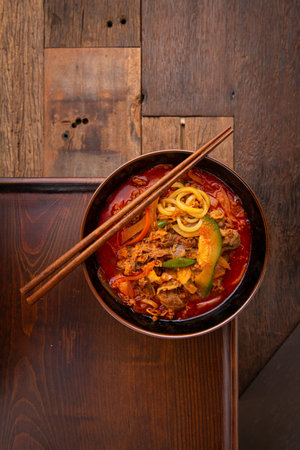 noodle soup with beef and vegetables on wooden backgroundの写真素材