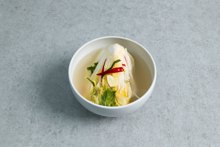 Korean food Kimchi in a white bowl on a gray background