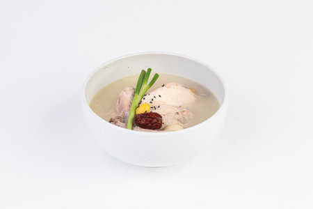 chicken soup in a bowl on a white background.の写真素材