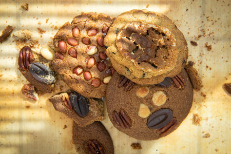 Oatmeal cookies with pecan nuts and raisins on wooden background