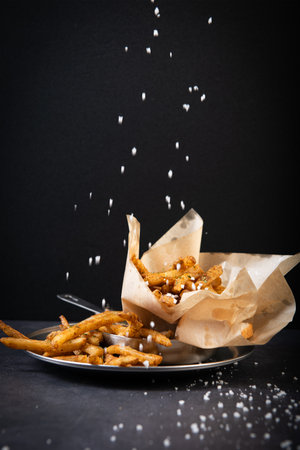Portion of croutons sprinkled with sugar on a black background