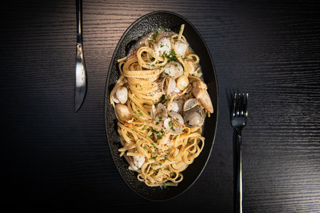 Spaghetti with chicken and mushrooms on a wooden tableの写真素材