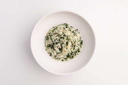 Rice in a white bowl on a white backgroundの写真素材