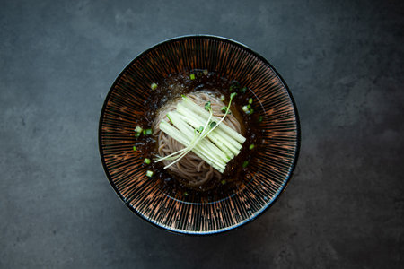 Japanese miso udon noodles in bowl on dark background, top viewの写真素材