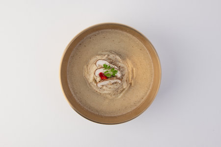 Bean cream soup in a bowl on white background, top viewの写真素材