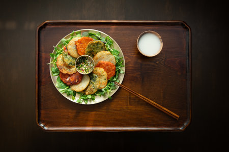 Potato pancakes with green salad on a wooden tableの写真素材