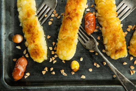 Crispy fried corn sticks with sausages and caramelized onionsの写真素材