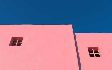 Empty concrete grunge wall. 3d rendering of city house with clear sky background. Detail of house exterior wall with small window. 3d rendering.の写真素材