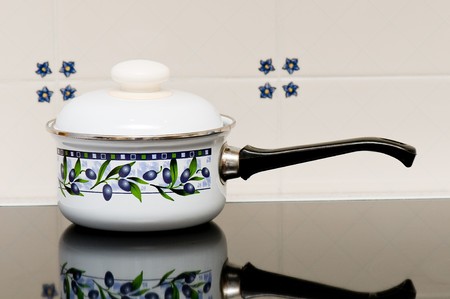 A white pot on a stoveの写真素材