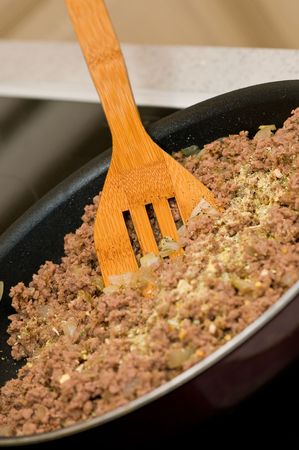 Meat grinder stir fry in a pan by the ladleの写真素材
