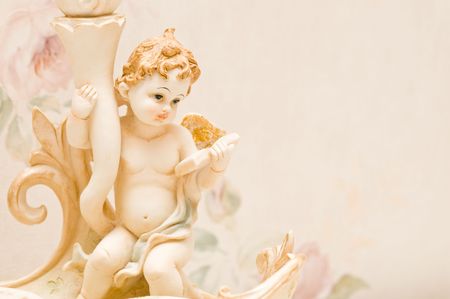 Cherub with book and golden wingsの写真素材