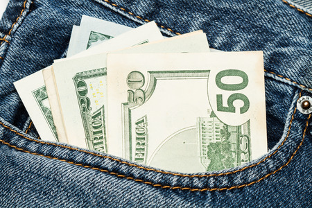 Dollar bills in a blue pocket jeansの写真素材