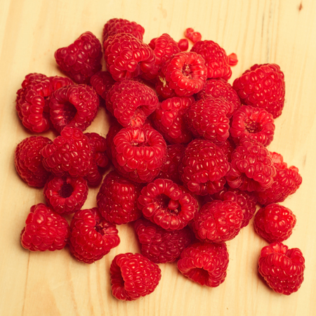 Raspberries on wooden table