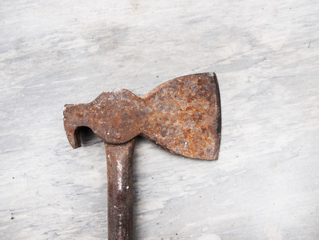 An old ax on a marble floor