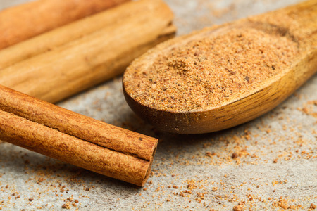 Cinnamon powder on a wooden spoon