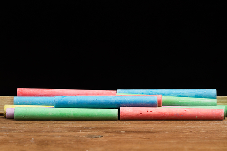 Colored chalks and a chalkboardの写真素材