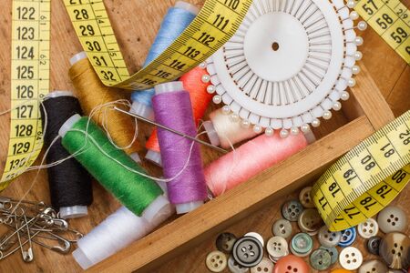 Sewing thread and sewing accessories in a wooden box