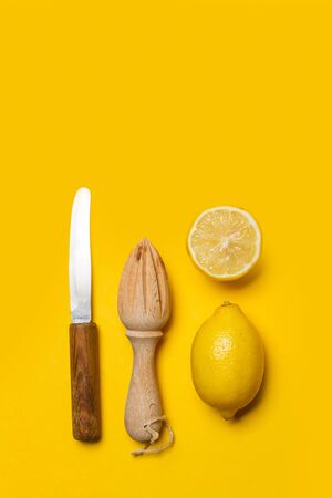 One lemon and a half with a wooden squeezerの写真素材