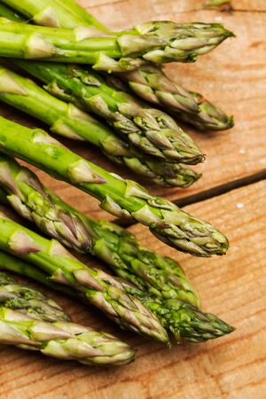 Green asparagus on a wooden tableの写真素材