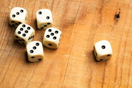 White dices on a wooden tableの写真素材
