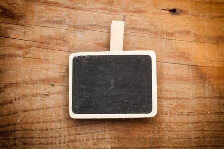 Little blackboard on a wooden table