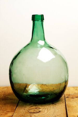 Vintage big crystal bottle on a wooden table