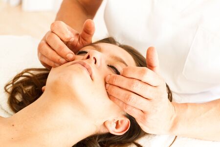 Massage and physiotherapy to a womanの写真素材