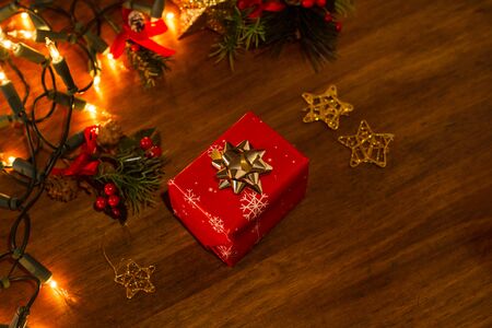 Christmas gift and ornaments on a wooden tableの写真素材