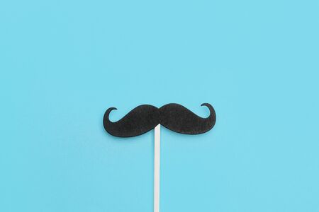 A black mustache on a blue backgroundの写真素材