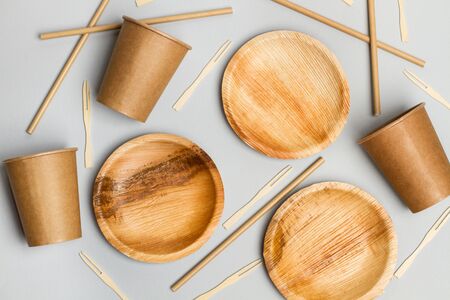 Paper cups, plates and sticks on a gray backgroundの写真素材