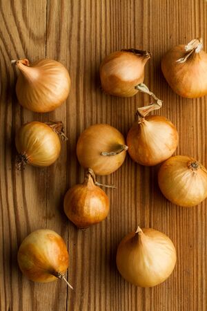 Small white french onions on a wooden tableの写真素材