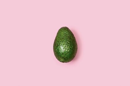 An avocado on a pink background
