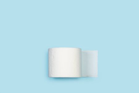 Toilet paper roll on a light blue background in a top viewの写真素材