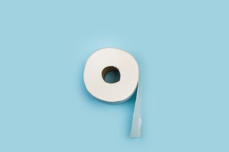 Toilet paper roll on a light blue background in a top viewの写真素材