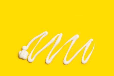 A draw made with suntan on a yellow backgroundの写真素材