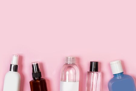 Bottles of skin tonic on a pink background in a top viewの写真素材