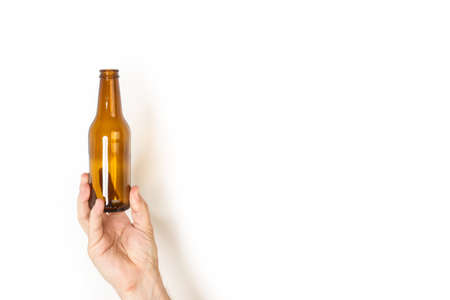 Man hand holding an empty bottle of beer on a white backgroundの写真素材