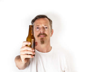 Man holding a bottle of beer in his hand on a white backgroundの写真素材
