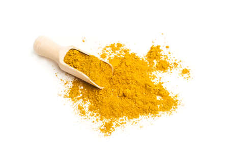 A wooden spoon with curry on a white background