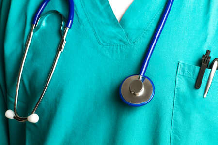 Doctor with a stethoscope hanging from his neck in a close up viewの写真素材