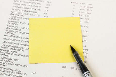 Medical test check printed in a white sheet and with a pen and a adhesive noteの写真素材