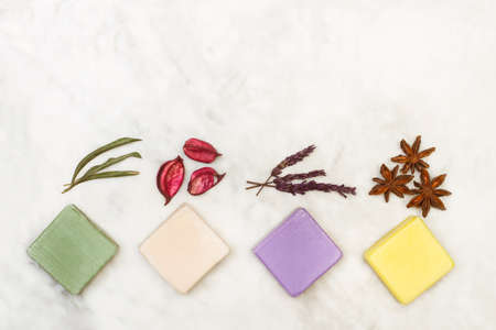 Colored soap bars on a white marble background in a top viewの写真素材