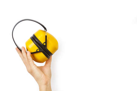 Woman hand holding earmuff for hearing safety protection headphonesの写真素材