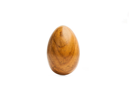 A wooden egg on a white background with copy spaceの写真素材