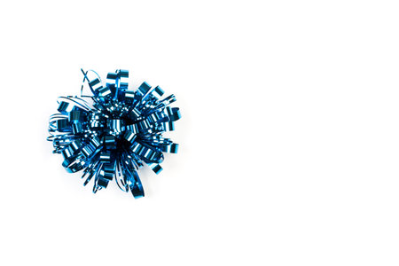 A gift blue bow decoration on a white backgroundの写真素材