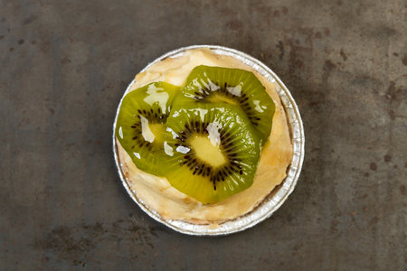 A kiwi pie on a metal table in a top viewの写真素材
